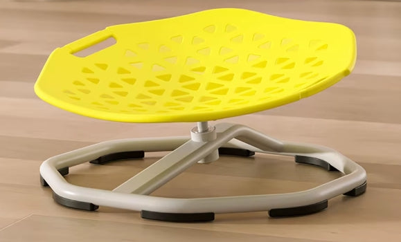 Yellow seat on a stand with a brown wooden floor background