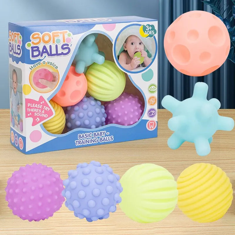 Box of soft balls with colorful balls on a wooden surface