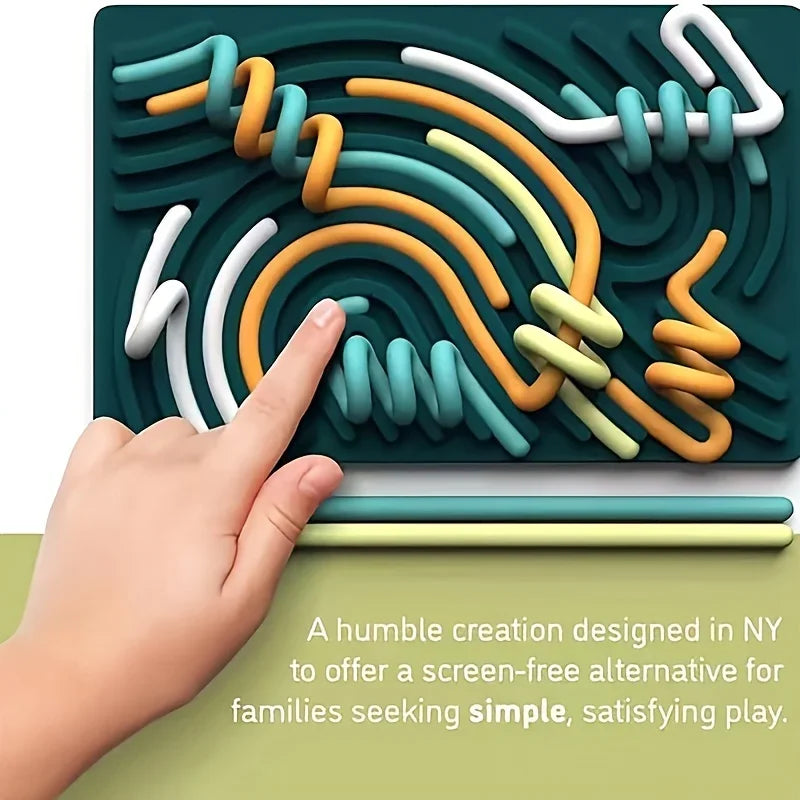Colorful maze board with hand interacting, set against a green background.