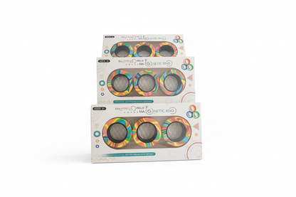 Three packages of a colorful ring product on a wooden surface with a blurred background.