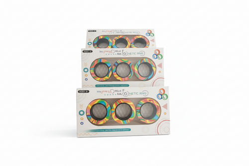 Three packages of a colorful ring product on a wooden surface with a blurred background.