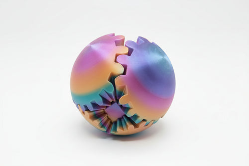 Colorful gear-shaped fidget ball on a wooden surface
