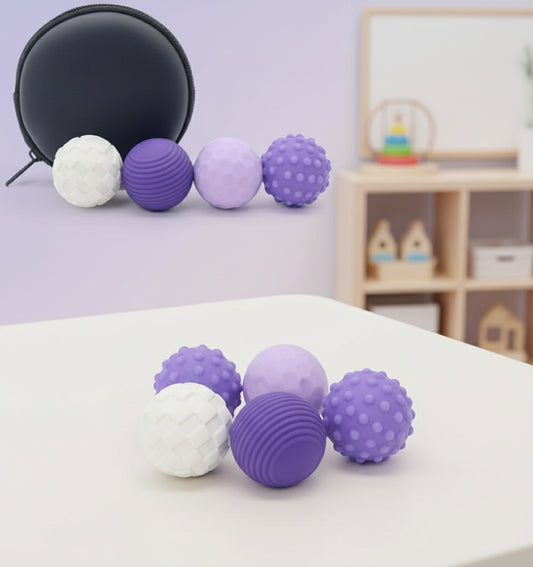 Set of purple, white, and lavender textured fidget balls with a black container on a white background.