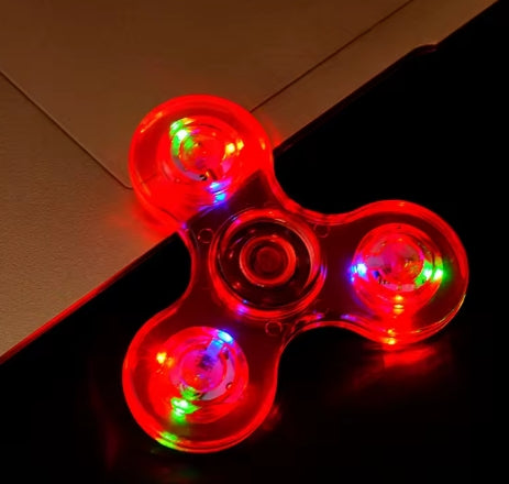 Fidget spinner with LED lights on a dark surface