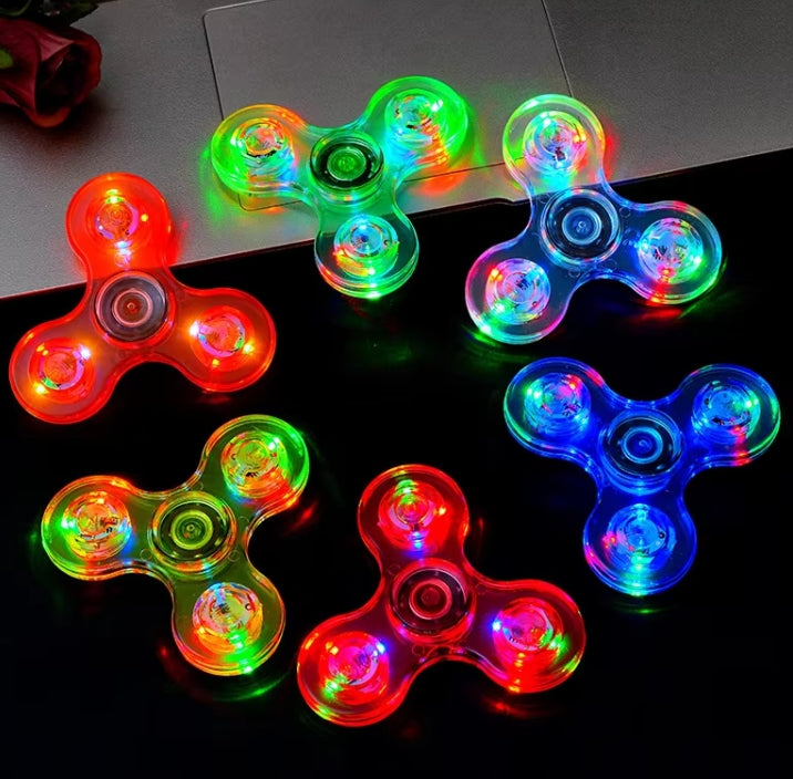 Colorful LED fidget spinners on a reflective surface