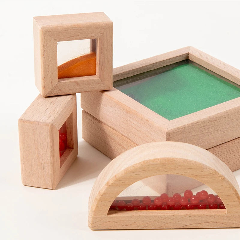 Wooden blocks with transparent sections revealing colored objects on a white background
