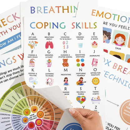 Educational posters on coping skills and emotions with a hand holding one of them.
