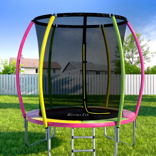 Trampoline with safety net on a grassy area with a clear sky