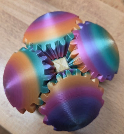 Colorful gear-shaped sensory ball on a wooden surface