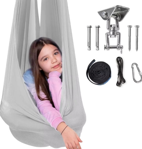 Child relaxing in a grey sensory hammock swing, promoting focus, emotional regulation and calm