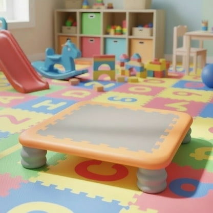 Mini kids indoor trampoline with an orange frame and sturdy white legs, designed for safe sensory play, balance training, and gross motor development.