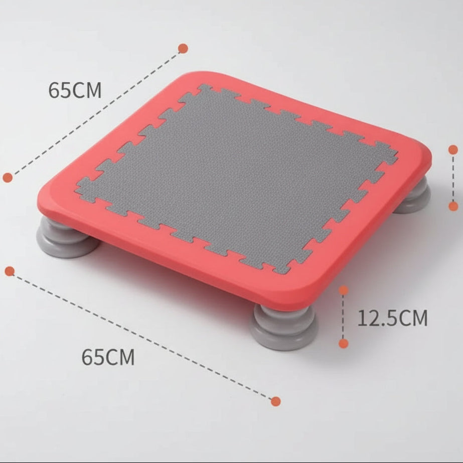 Red mini kids’ sensory trampoline with a grey jumping surface and sturdy grey legs, measuring 65cm by 65cm and 12.5cm high, designed for balance training, sensory play, and gross motor development.