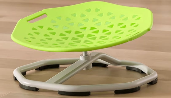 Green and white sit-stand chair on a wooden floor