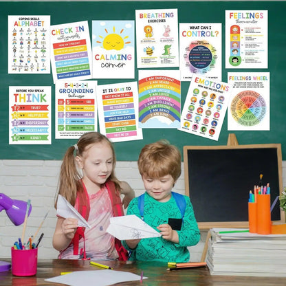 Children sitting at a desk with educational posters on a green chalkboard wall.