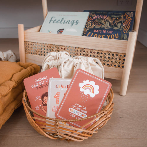 Emotion regulation cards for kids displayed in a woven basket with cotton bag