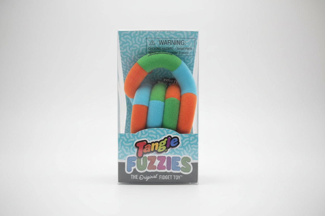 Packaged Tangle Fuzzies fidget toy on a wooden surface