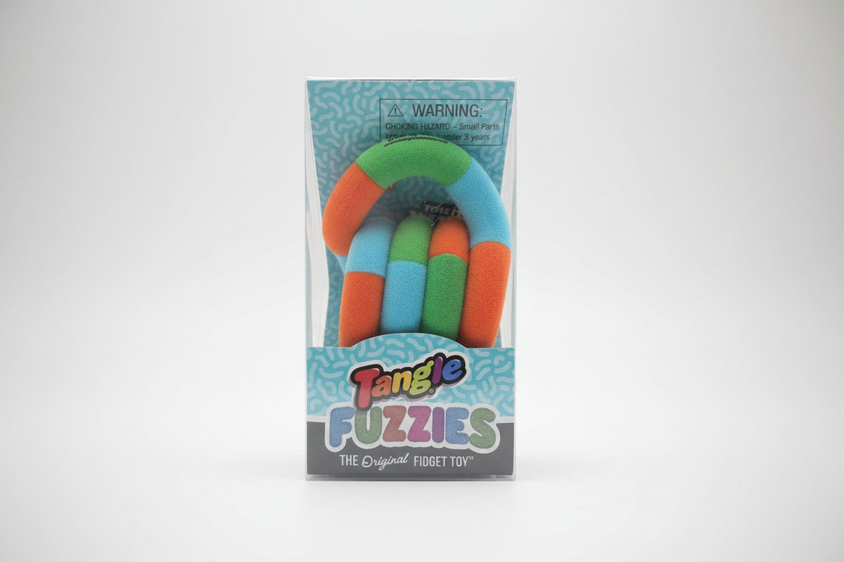 Packaged Tangle Fuzzies fidget toy on a wooden surface