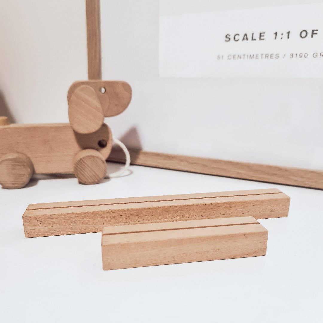 Wooden toy dog and two wooden bars on a white surface with text overlay.